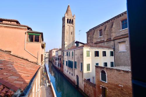 a view of a canal in a city with a clock tower at Palazzetto Barnaba in Venice