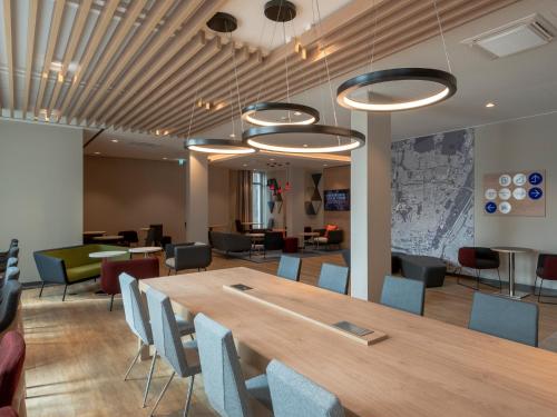 a conference room with a wooden table and chairs at Holiday Inn Express - MUNICH NORTH by IHG in Munich