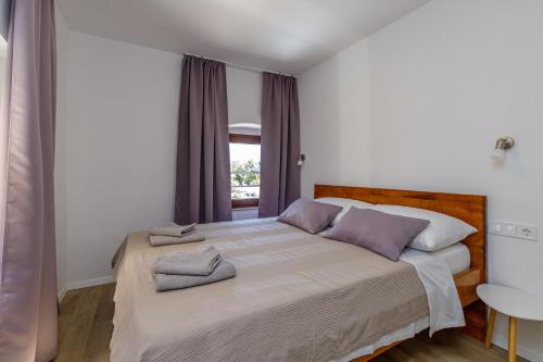 a bedroom with a bed with two towels on it at House Aves 2 in Kaštelir