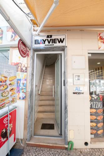an entrance to a grocery store with a sign above the door at BayView Nazaré in Nazaré