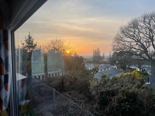 a sunset seen from a window of a house at Turlin Valley in Poole