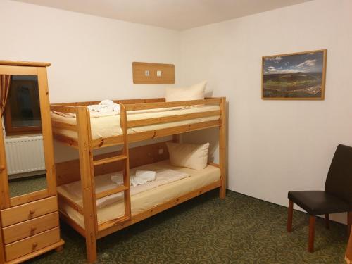 a room with two bunk beds and a mirror at guesthouse Elbsandstein Appartement Lilienstein in Rathmannsdorf