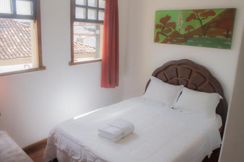 מיטה או מיטות בחדר ב-POUSADA FLOR DE LIS