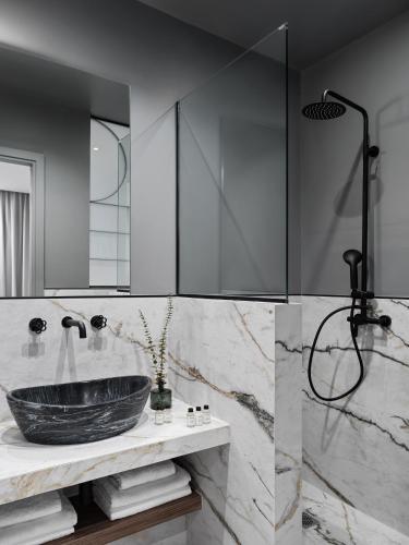 a bathroom with a sink and a shower at Athens City View Urban Suites in Athens