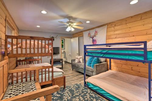 a bedroom with two bunk beds and a living room at A-Frame Home with 3 Decks and Lake Arrowhead Views! in Lake Arrowhead