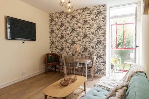 a living room with a couch and a table at Au cœur des Remparts de Guérande: logement pour 4 in Guérande