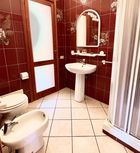a bathroom with a toilet and a sink at Casa Greta in Costa Rei