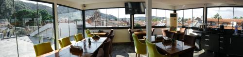 a restaurant with tables and chairs and a view of the city at Nefis Hotel City in Fethiye