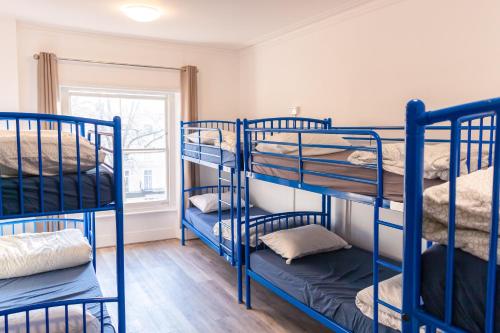 a room with blue bunk beds in a room at Urbany Hostel London 18-40 Years Old in London