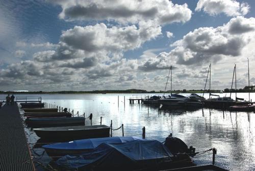 een groep boten aangemeerd op een dok in het water bij Ruhige Wohnung mit Terrasse nur 5 Minuten zur Müritz in Marienfelde