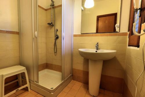 a bathroom with a sink and a shower at Testa di Monaco - Basic Beach Accommodations in Capo dʼOrlando