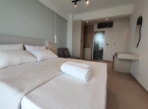a hotel room with two beds with towels on them at Onar in Sarti in Sarti