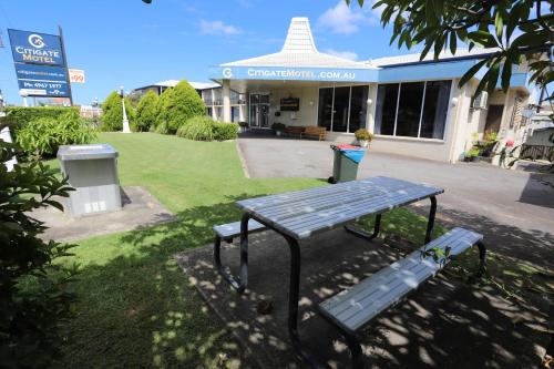 a picnic bench sitting in front of a building at Citigate Motel Newcastle in Newcastle