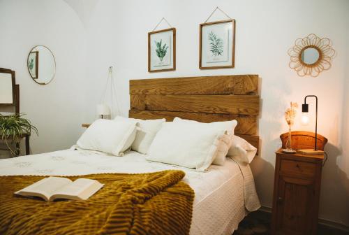 a bedroom with a bed with two books on it at CASA RURAL LA LIBERTAD in Monesterio