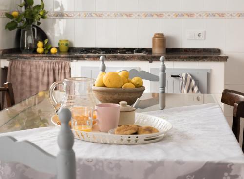 a table with a plate of food and a bowl of fruit at CASA RURAL LA LIBERTAD in Monesterio