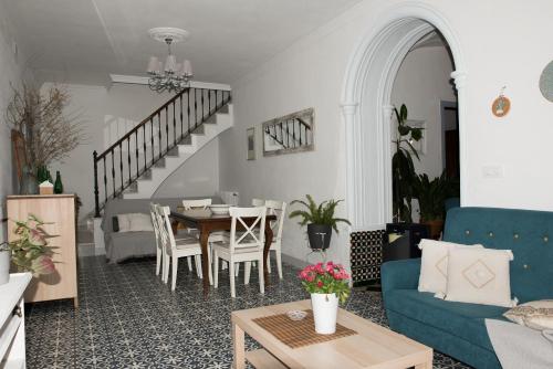 a living room with a table and a blue couch at CASA RURAL LA LIBERTAD in Monesterio