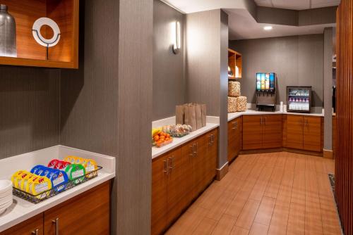 a large kitchen with wooden cabinets and food on the counter at Sonesta Select Nashville Airport Suites in Nashville