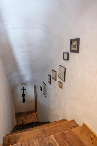 a hallway with a cross and pictures on the wall at Country House Trata in Kranjska Gora