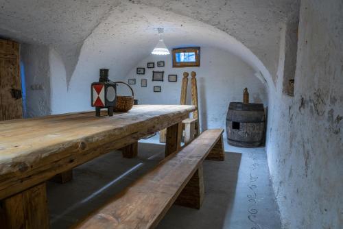 a room with a long wooden table and a barrel at Country House Trata in Kranjska Gora