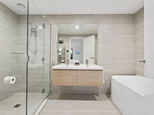 a bathroom with a sink and a tub and a shower at Woods Villa Tui in Queenstown