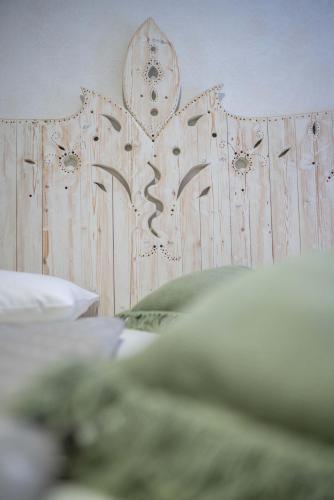 a wooden headboard of a bed in a bedroom at Country House Trata in Kranjska Gora