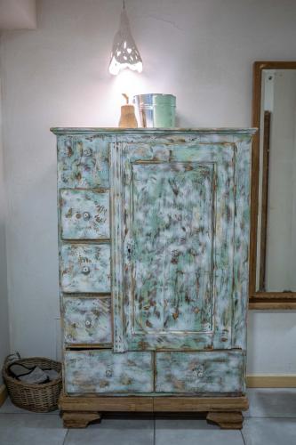 an old wooden dresser with a light on top at Country House Trata in Kranjska Gora