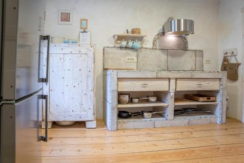 a kitchen with an old stove and a refrigerator at Country House Trata in Kranjska Gora