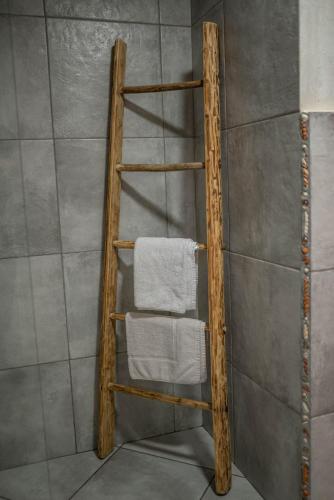 a wooden towel rack in a bathroom with a towel at Country House Trata in Kranjska Gora