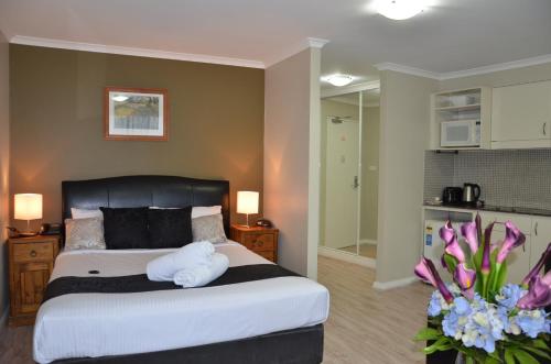 a bedroom with a bed with two towels on it at Napoleon On Kent in Sydney