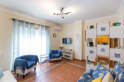 a living room with two chairs and a couch at Villa Marquez Apartments in Vila Real de Santo António