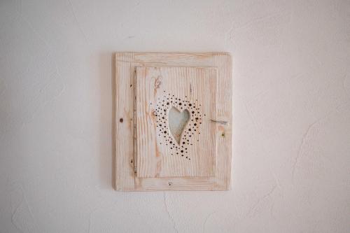 a lightswitch with a heart on a wall at Country House Trata in Kranjska Gora