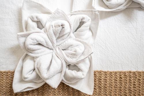 a towel with a flower on top of a bed at Country House Trata in Kranjska Gora