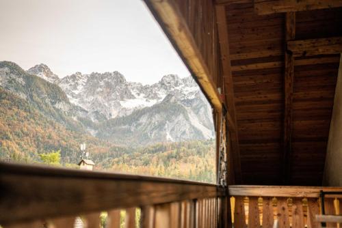 a window of a cabin with a view of mountains at Country House Trata in Kranjska Gora