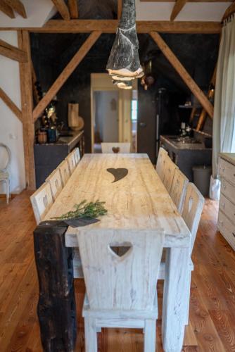 a wooden table with chairs in a room at Country House Trata in Kranjska Gora