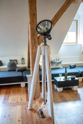 a mirror on a tripod in a living room at Country House Trata in Kranjska Gora