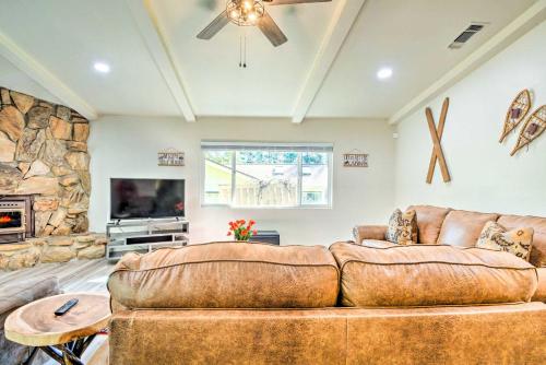 a living room with a couch and a fireplace at Furnished Deck and Fire Pit Sherwood Forest Cabin in Twain Harte