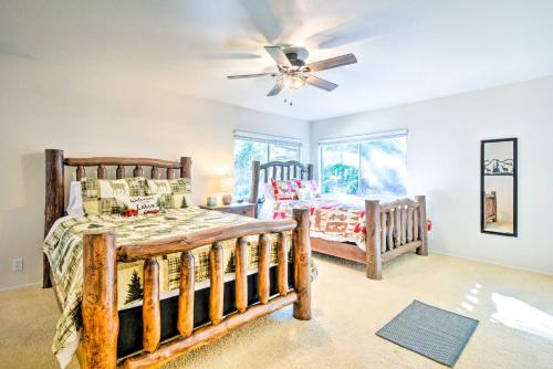 a bedroom with two beds and a ceiling fan at Furnished Deck and Fire Pit Sherwood Forest Cabin in Twain Harte
