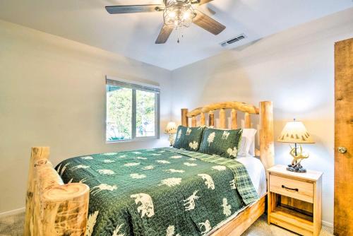 a bedroom with a bed and a ceiling fan at Cabin with Deck Located in The Sherwood Forest! in Twain Harte
