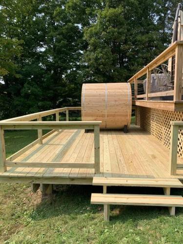 a wooden deck with a barrel on top of it at Harpersfield House /North West Catskills + sauna in Jefferson