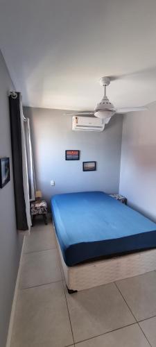 a bedroom with a blue bed in a room at Apart-Hotel Golden Lake 2 in Arraial do Cabo