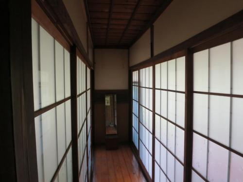 an empty hallway with windows in a building at Guesthouse Nishiki in Chichibu