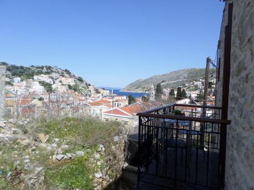 a view of a city from a balcony at GRANDMA'S HOUSE in Symi