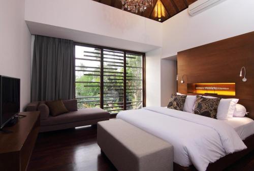 a bedroom with a large bed and a large window at Abivilla in Seminyak