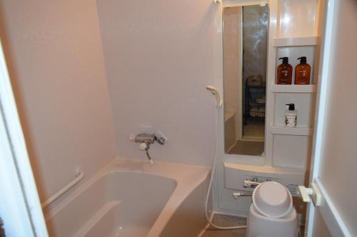 a small bathroom with a tub and a toilet at Blue 200-1 / Vacation STAY 3808 in Utasutsu