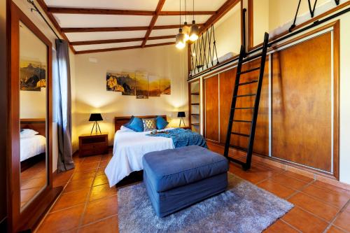 a bedroom with a bunk bed and a ladder at O Refúgio - Espaço natural, amplo e privado in Angra do Heroísmo