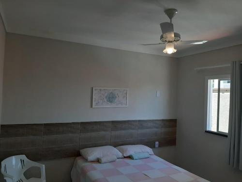 a bedroom with a bed and a ceiling fan at atalaia mar I in Aracaju