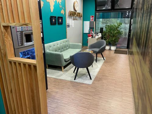 a waiting room with a couch and chairs in a building at Andaina in Sarria
