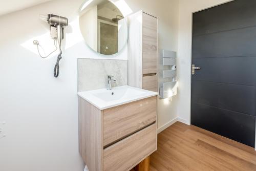 a bathroom with a sink and a mirror at DOWNTOWN LOFT - CENTRE VILLE - WiFi - NETFLIX in Amiens
