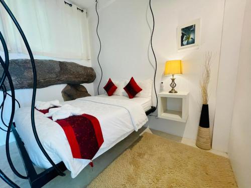 a bedroom with a bed in a room at Monkey Flower Villas in Koh Tao