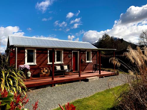 a small wooden cabin with a large wooden deck at Red Cottages Staveley in Staveley